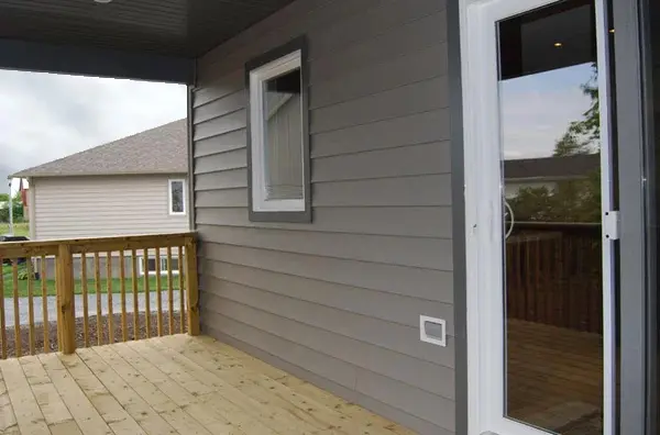 Grey vinyl siding with window and patio door on Ottawa home deck