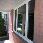 White-trimmed windows on red brick exterior of home